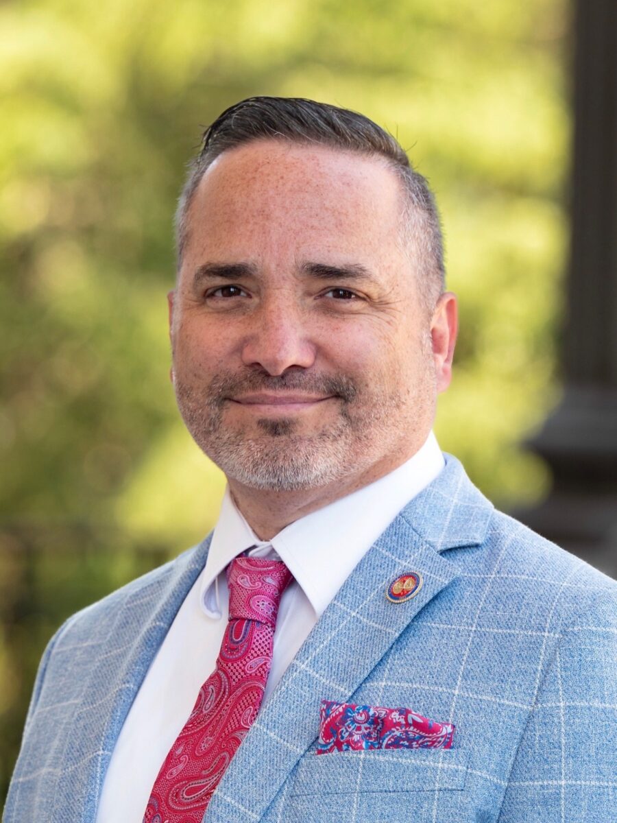 Portrait of James Teeple in a light blue jacket and red paisley tie