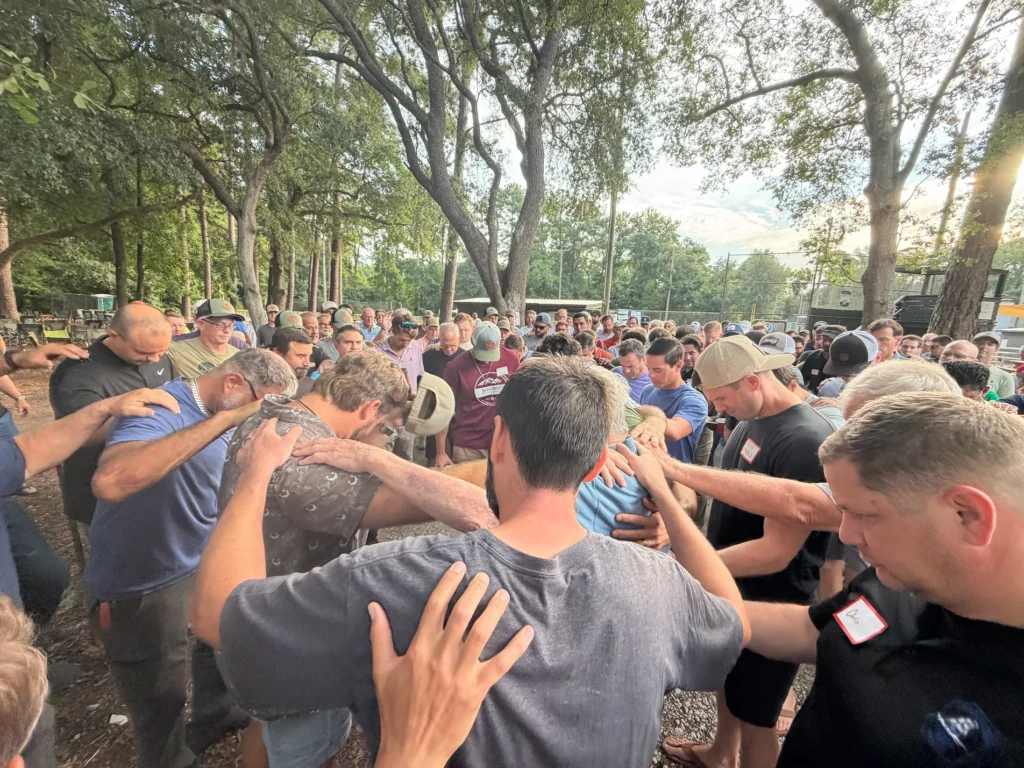 Red Truck Men joining together in prayer